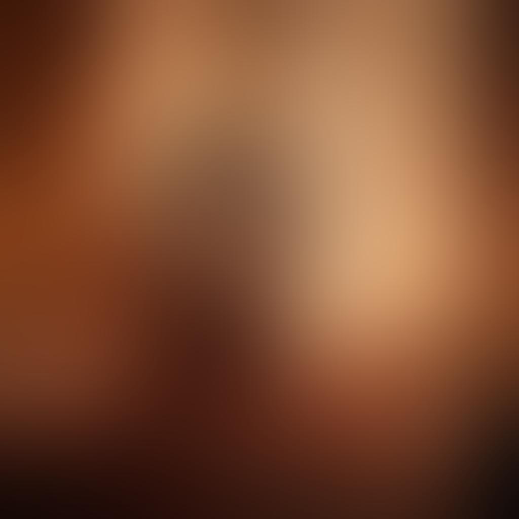 A cozy, dimly-lit bedroom adorned with soft, flowing fabrics and warm candlelight, featuring a couple entwined in a passionate embrace, their silhouettes illuminated by a gentle moonlight seeping through a window. Surrounding them are romantic elements like rose petals and a bottle of wine, creating an atmosphere of intimacy and desire. Soft focus and warm tones enhance the allure of the scene. super-realistic. warm colors. soft lighting.